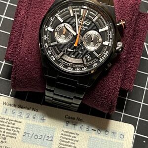 Seiko Black and Silver Men's Watch with Orange Accents SSB399